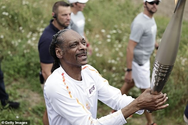 Snoop Dogg carries Olympic torch ahead of opening ceremony in