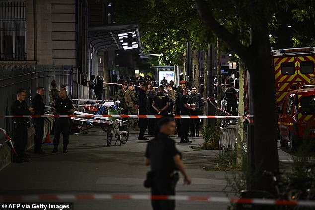 A convicted murderer was arrested in Paris tonight after stabbing a uniformed soldier carrying out anti-terrorist duties at one of the French capital's main train stations. Pictured: French firefighters and soldiers at the scene after the attack