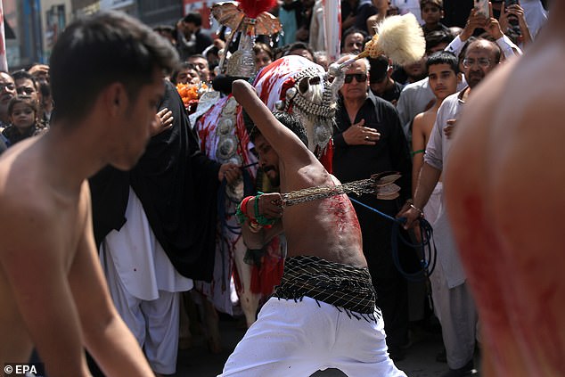 A Shiite Muslim scourges himself on the eve of Ashura processions in Peshawar, Pakistan, on Tuesday