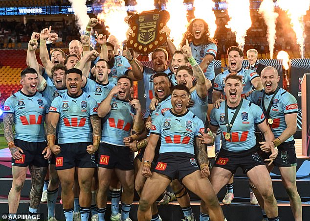 Trbojevic (pictured centre, holding the shield after Wednesday night's win) has been ridiculed online after his playing time was cut in this Origin series