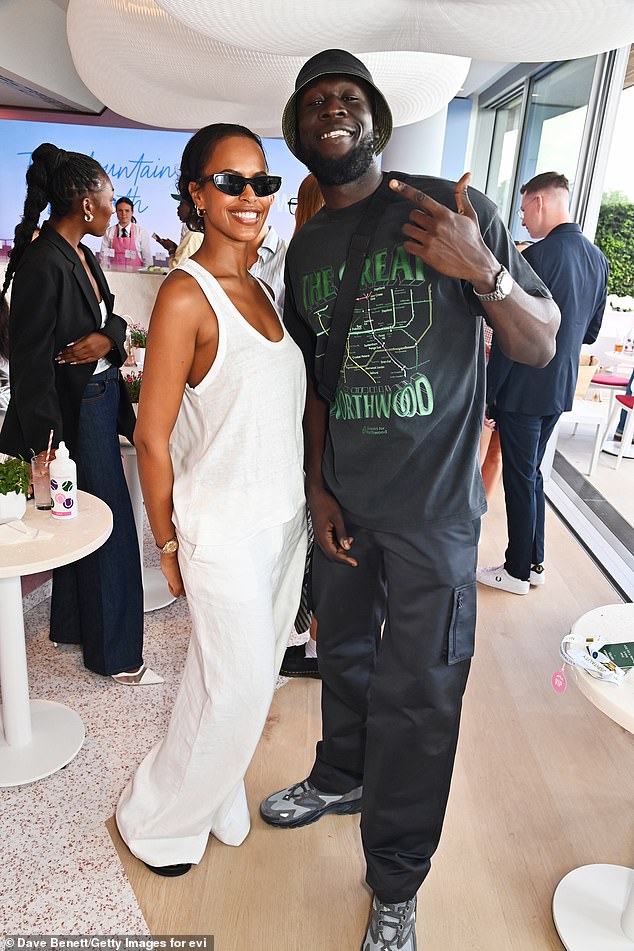 Stormzy showed off his cool sense of style and looked in great spirits as he mingled with Sabrina Elba (seen) and AJ Odudu in Evian's VIP Wimbledon suite on Thursday