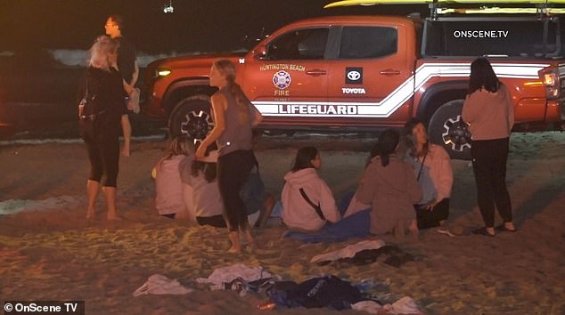 Children were seen comforting each other after their 15-year-old friend disappeared during a nighttime swim in Huntington Beach on Sunday night