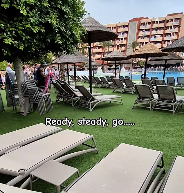 Images show sunbathers with towels in their hands at the Hotel Village in Benalmadena, ready to grab a row of beds for their families