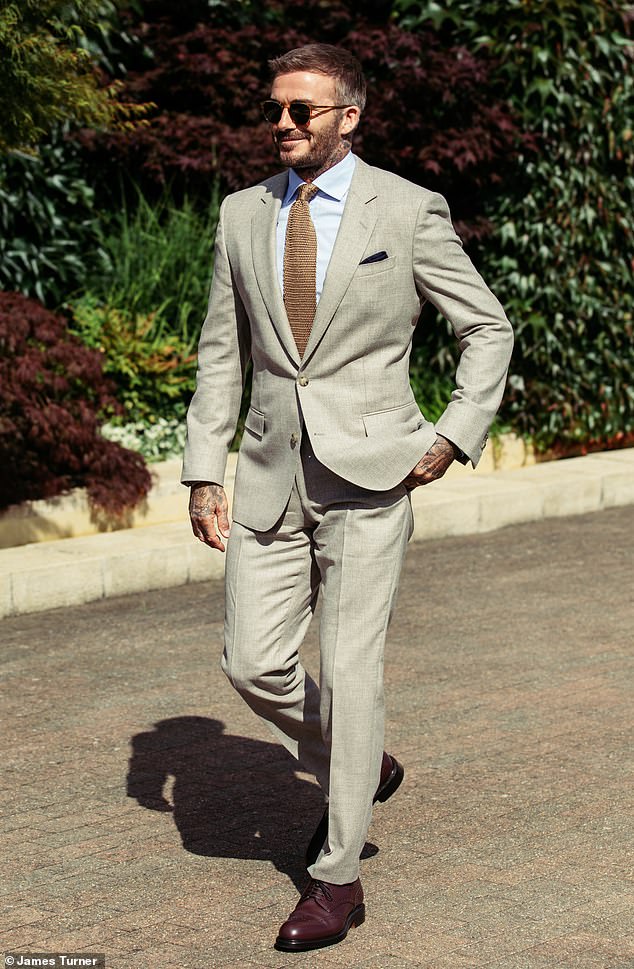 The former England captain was seen arriving at the tennis match wearing a beige single-breasted BOSS canvas suit in beige, which he paired with a blue cotton shirt
