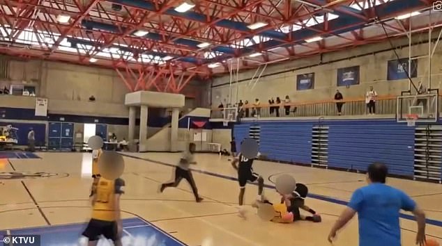 This image shows the moment a young basketball player stomps on his opponent's head