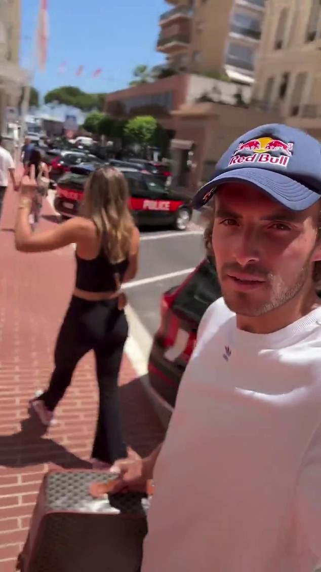 Tsitsipas keeps a straight face as he insists his tennis star girlfriend Badosa carry her luggage as they walk at a frenetic pace while she gives a single-digit answer