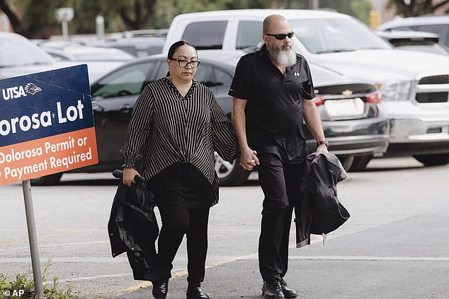 Janet Mello, the Texas woman who defrauded the U.S. military of more than $100 million, has been sentenced to 15 years in prison. (Pictured: Mello with her husband outside the courthouse)