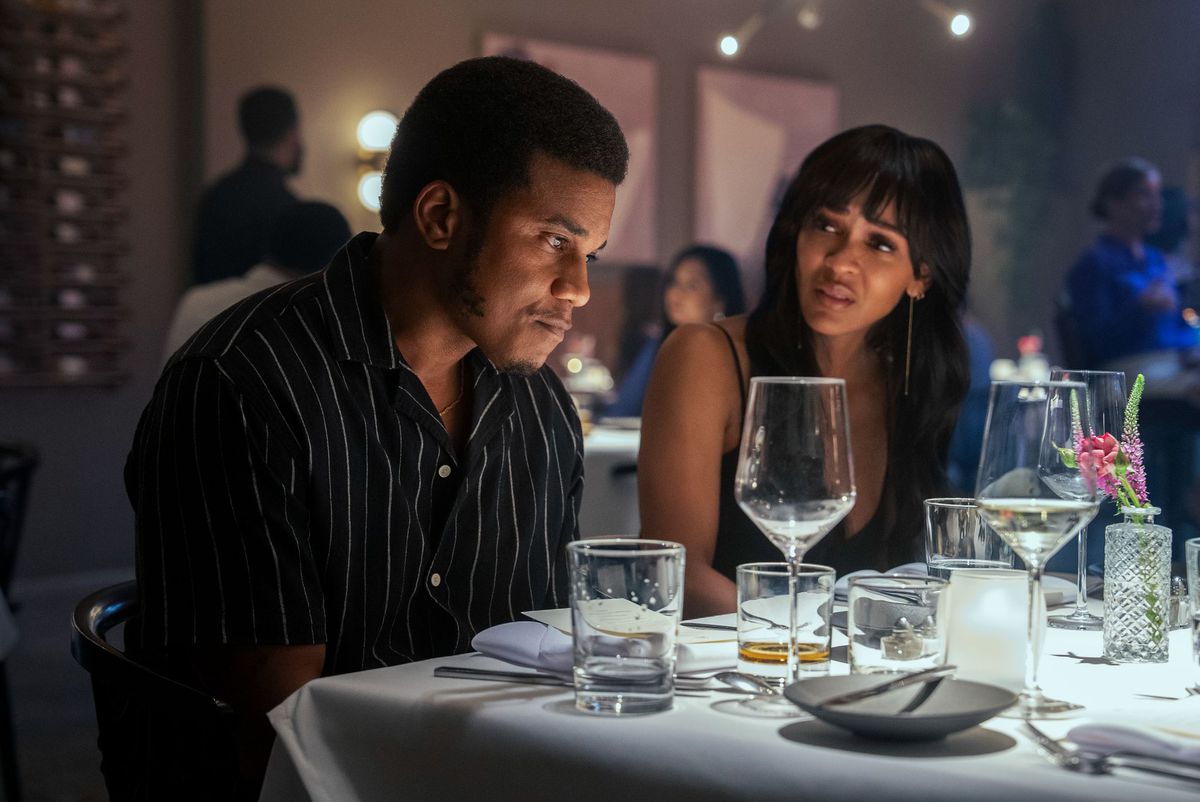 Two people are sitting at a tense dinner 