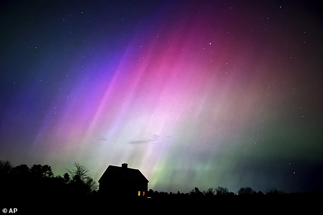 As a massive solar storm hits Earth tonight, the Northern Lights will light up the skies over much of the UK. Pictured: Northern Lights during May's solar storm