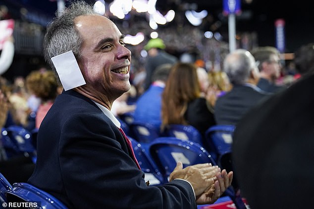 A participant wears a "bandage" on his ear during Day 2 of the Republican National Convention (RNC), at the Fiserv Forum in Milwaukee, Wisconsin, U.S., July 16, 2024