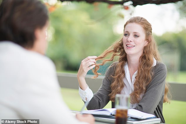 The woman leans forward and rubs my husband's arm conspiratorially, her long auburn curls caressing his sleeve