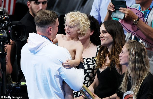 Adam Peaty pictured hugging his three-year-old son after winning silver at the Olympic Games on Sunday