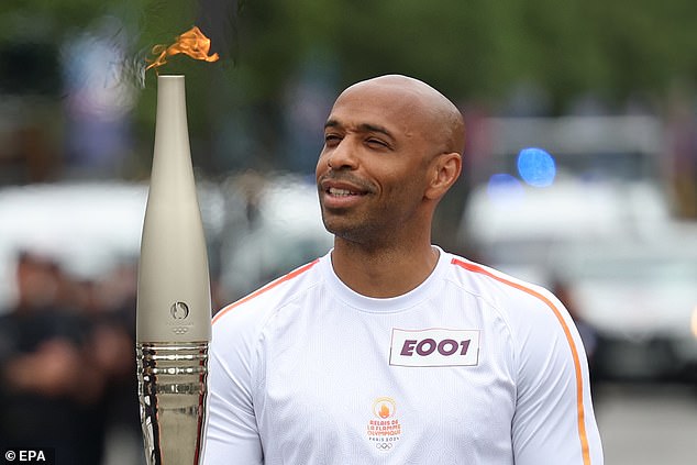 Thierry Henry carried the Olympic torch down the Champs-Elysees in Paris on Sunday