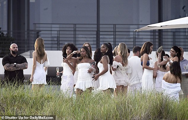 Guests are seen chatting at the sports mogul's posh estate, dressed to the nines in aesthetically pleasing outfits