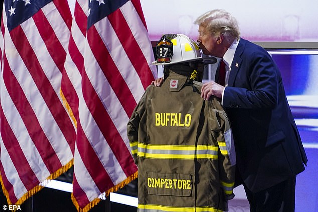 Donald Trump kisses Corey Comperatore's helmet during his speech at the Republican National Convention. The uniform was on display on stage as Trump delivered his acceptance speech