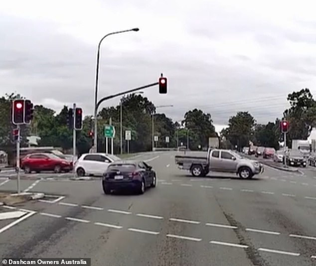 Dashcam footage showed a blue Mazda hatchback running a red light and driving at high speed through an intersection before crashing into traffic (pictured)