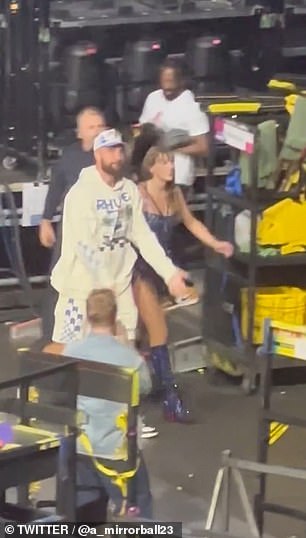 Fans went wild when they saw Kelce appear from behind the stage to escort Swift back to her dressing room