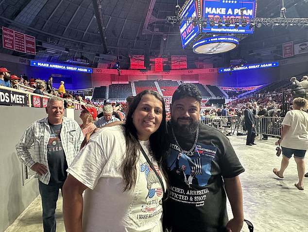 Jennifer Braga, 32, and her husband Wesley Braga, 37, attend a Trump rally in Charlotte, North Carolina on Wednesday. Jennifer told DailyMail.com that Kamala Harris taking over from Joe Biden 'hasn't changed anything because the Republican Party is really united'