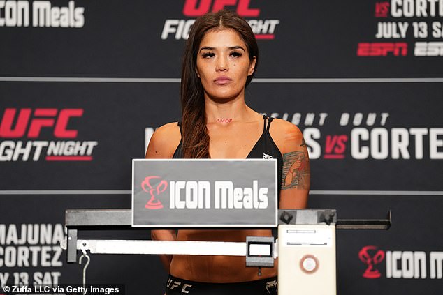 Cortez poses on the scale during the UFC weigh-in at the Sheraton Downtown Denver Hotel