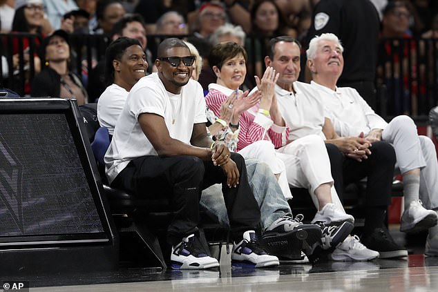 The singer had a big smile on his face as he sat on the sidelines of the Michelob ULTRA Arena on Tuesday