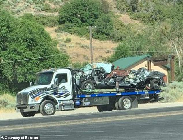 The mangled wreckage of the family's SUV is seen before it was towed away