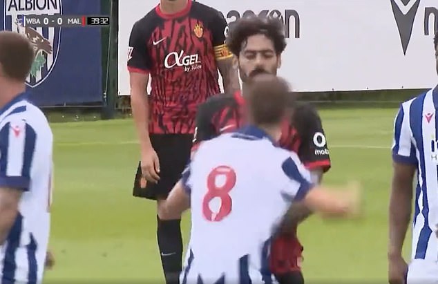 Baggies midfielder Jayson Molumby (front) punches an opponent during a friendly match.