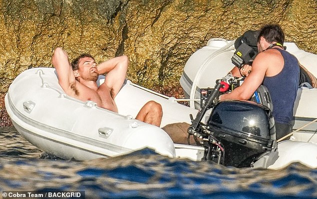 James was also seen relaxing on board a dinghy, with his hands behind his head and his muscular torso on full display