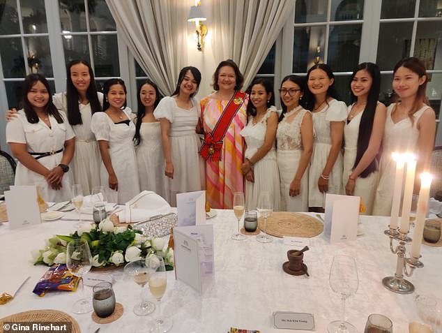 Gina Rinehart (pictured center) poses with some of the young Cambodian women she has helped educate through the charitable efforts of her company Hancock Prospecting