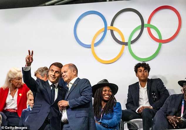 President Emmanuel Macron (left) speaks with German Chancellor Olaf Scholz (right) during the opening ceremony