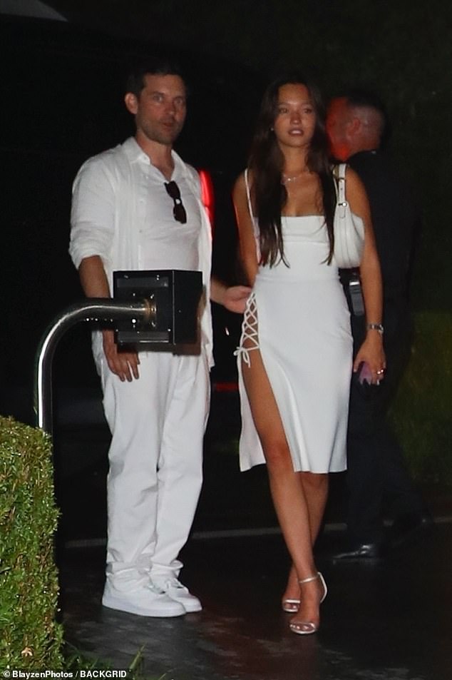 Tobey Maguire, 49, was spotted leaving Michael Rubin's All-White party with a young model on his arm on Independence Day