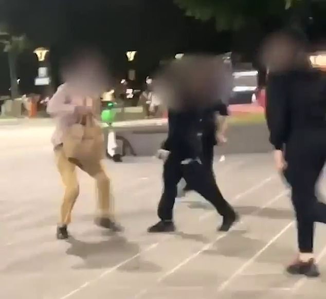 A food delivery driver (pictured left) was surrounded by a group of youths who pushed him to the ground in Southbank, Melbourne