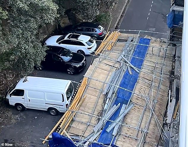 The three-storey scaffolding wall was blown down by a car driving along Kangaroo Lane in Manly on Sydney's Northern Beaches at around 4.20pm on Saturday