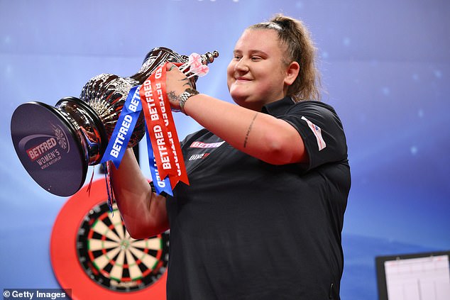 Beau Greaves pictured holding up the Women's World Matchplay trophy in Blackpool yesterday. She has since turned down the chance to play in the World Championship