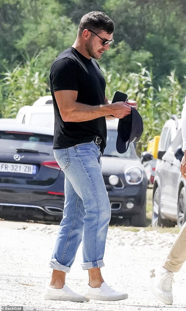 Zac Efron showed off his muscular biceps in a black short-sleeved T-shirt in St. Tropez this week