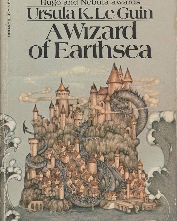 The cover of A Wizard of Earthsea, featuring a fantastic island city with a dragon surrounding it