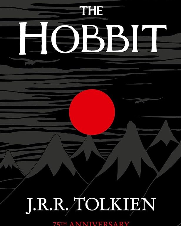 A cover of The Hobbit, featuring a red moon above a black mountain range