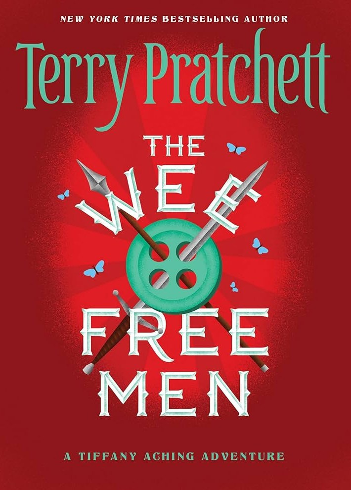 The cover of Wee Free Men, a red background with a small tea bud used as a shield with spears running across it