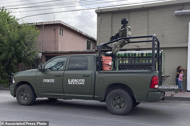 Mexican soldiers stand guard outside the Tamaulipas Chamber of Commerce, where president Julio Cesar Almanza was killed, in Matamoros, Mexico, Tuesday, July 30, 2024. (AP Photo/Veronica Cisneros)