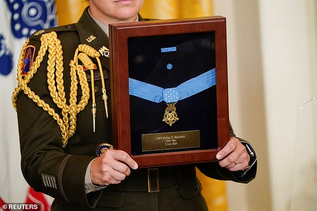 Austin said the panel will review each award. A Medal of Honor is held aloft here during a ceremony at the White House