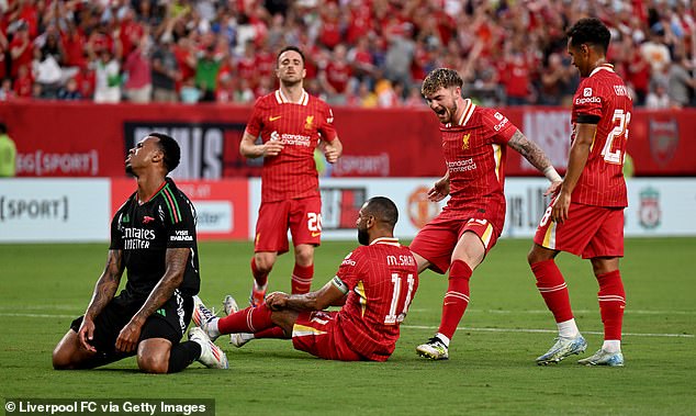 Mohamed Salah celebrates from the floor after putting Liverpool ahead against Arsenal