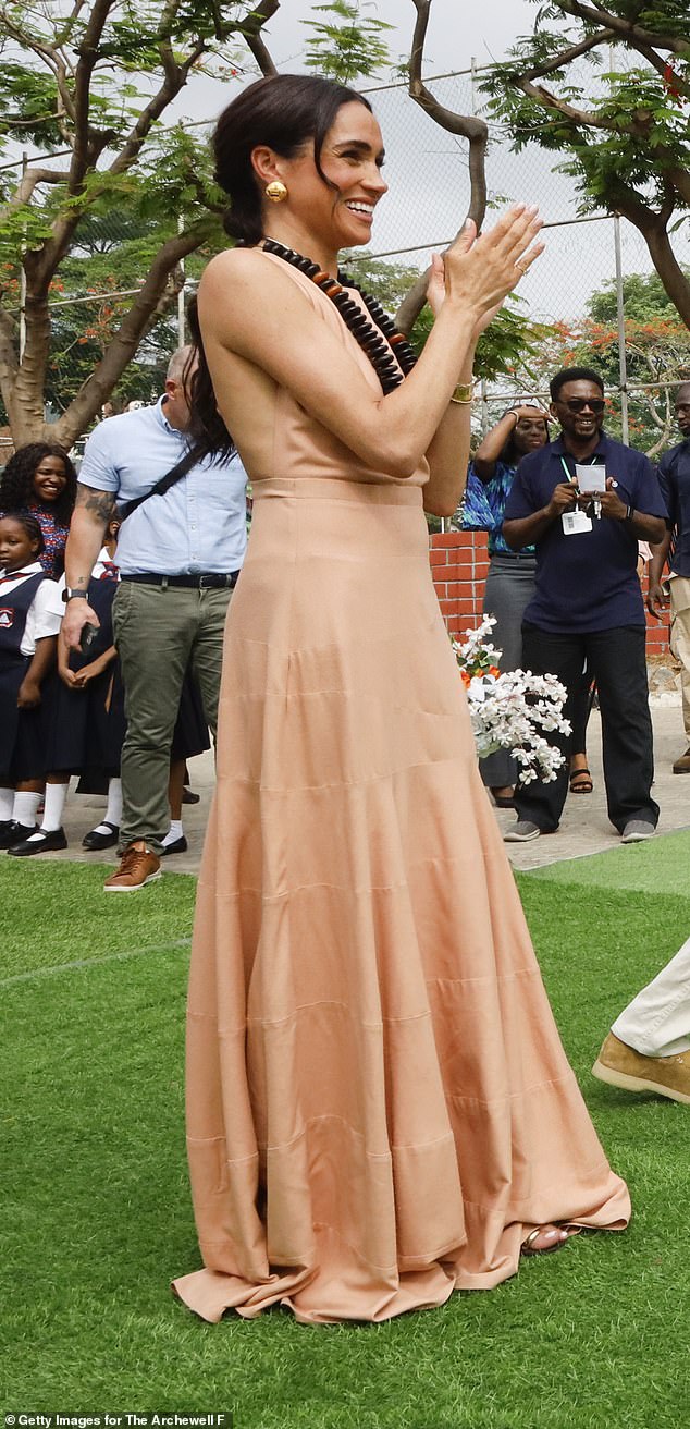 Meghan Markle wears a long pleated dress while visiting Lightway Academy in Abuja, Nigeria in May 2024