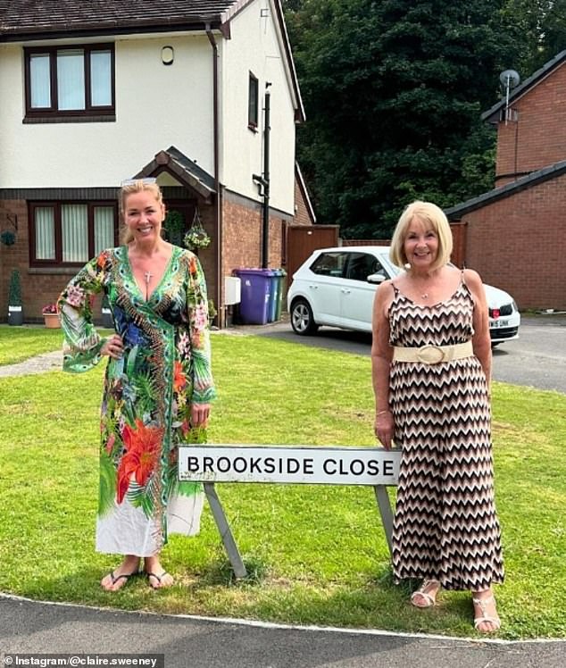 Claire looked stunning during the outing in a plunging green patterned wrap dress as she posed alongside her mother Kathleen