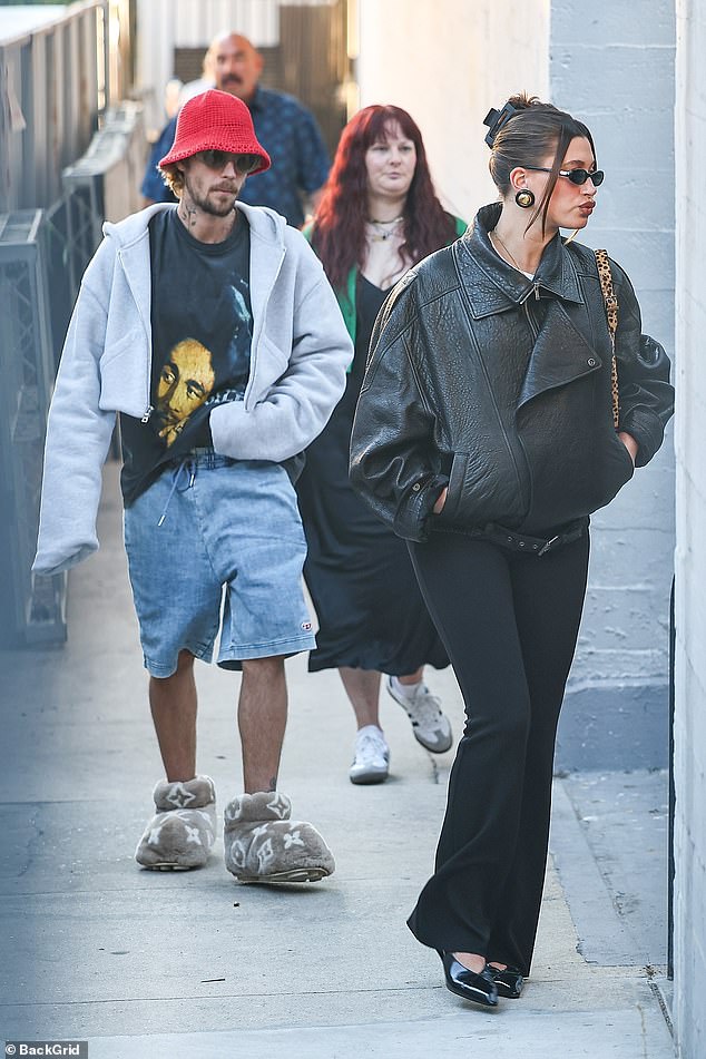 The pregnant model looked too cool for school in a sleek black leather jacket and matching ensemble, while the pop star opted for a more casual, all-over-the-place look with an oversized pair of furry slippers.