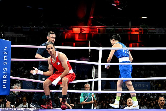 The Italian fighter (in blue) refused the handshake and fell to the canvas, appearing to wipe away a tear. Winner Khelif is pictured in red as her opponent leaves the ring