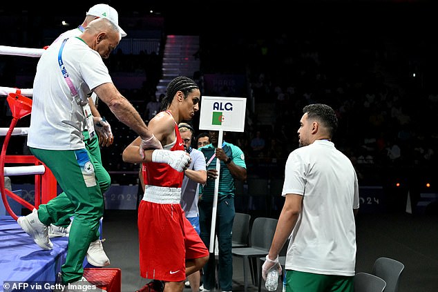 Algeria's Imane Khelif (in red) leaves after her victory in this morning's Olympic boxing match