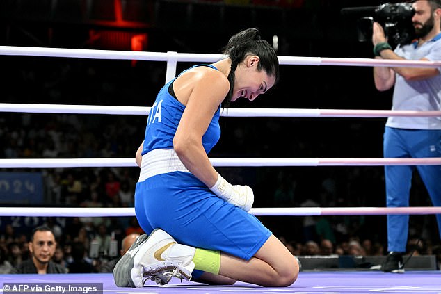 The Italian boxer fell to her knees after giving up and was seen crying in the ring