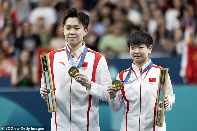 The world number 1's paddle was broken by photographers as he celebrated his gold medal