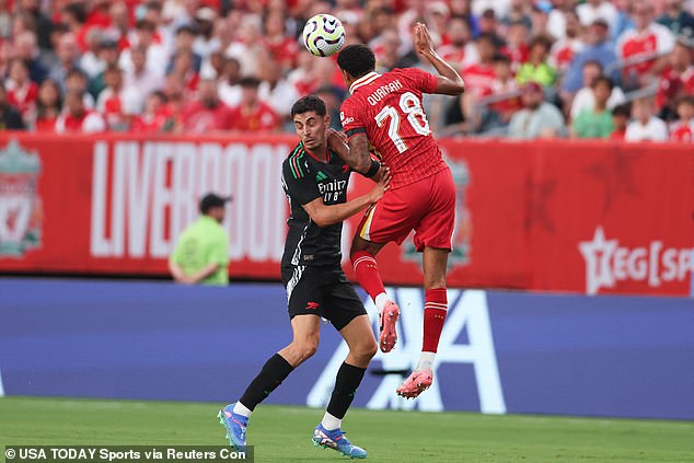 Quansah (right) pictured winning a header during this week's friendly against Arsenal