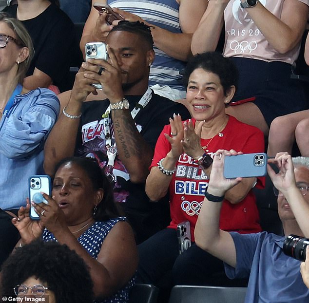 Jonathan, 29, was filmed filming Simone, 27, as she performed, and cheered loudly when she completed her jump, for which she earned a score of 15.766, placing her in first place so far