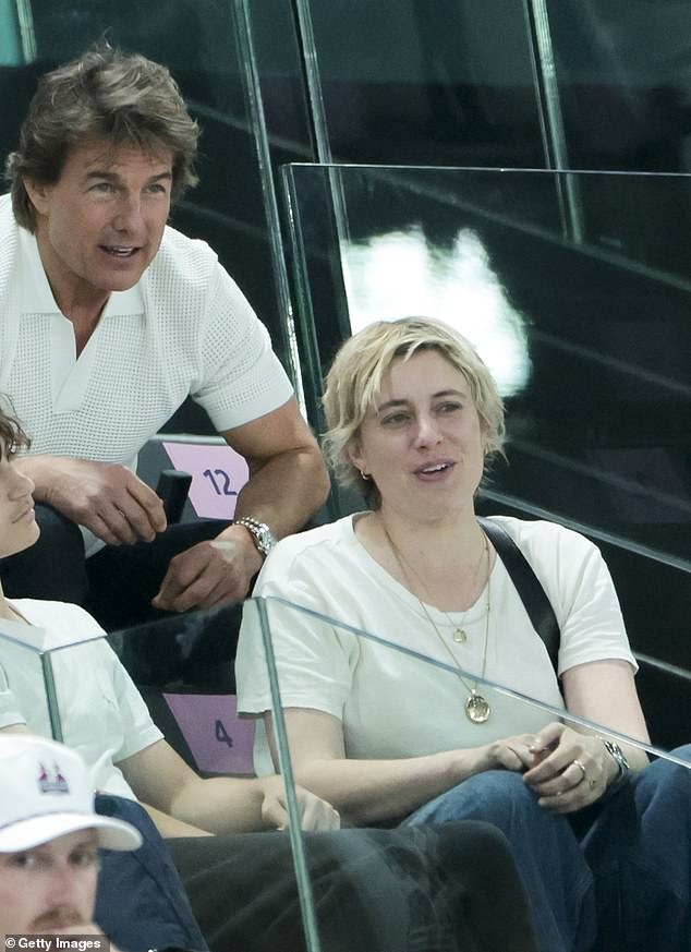 In the video, shown after his live broadcast, he travels on a plane and flies the flag from France to California before skydiving into the Hollywood sign; seen with Greta Gerwig, the director of Barbie